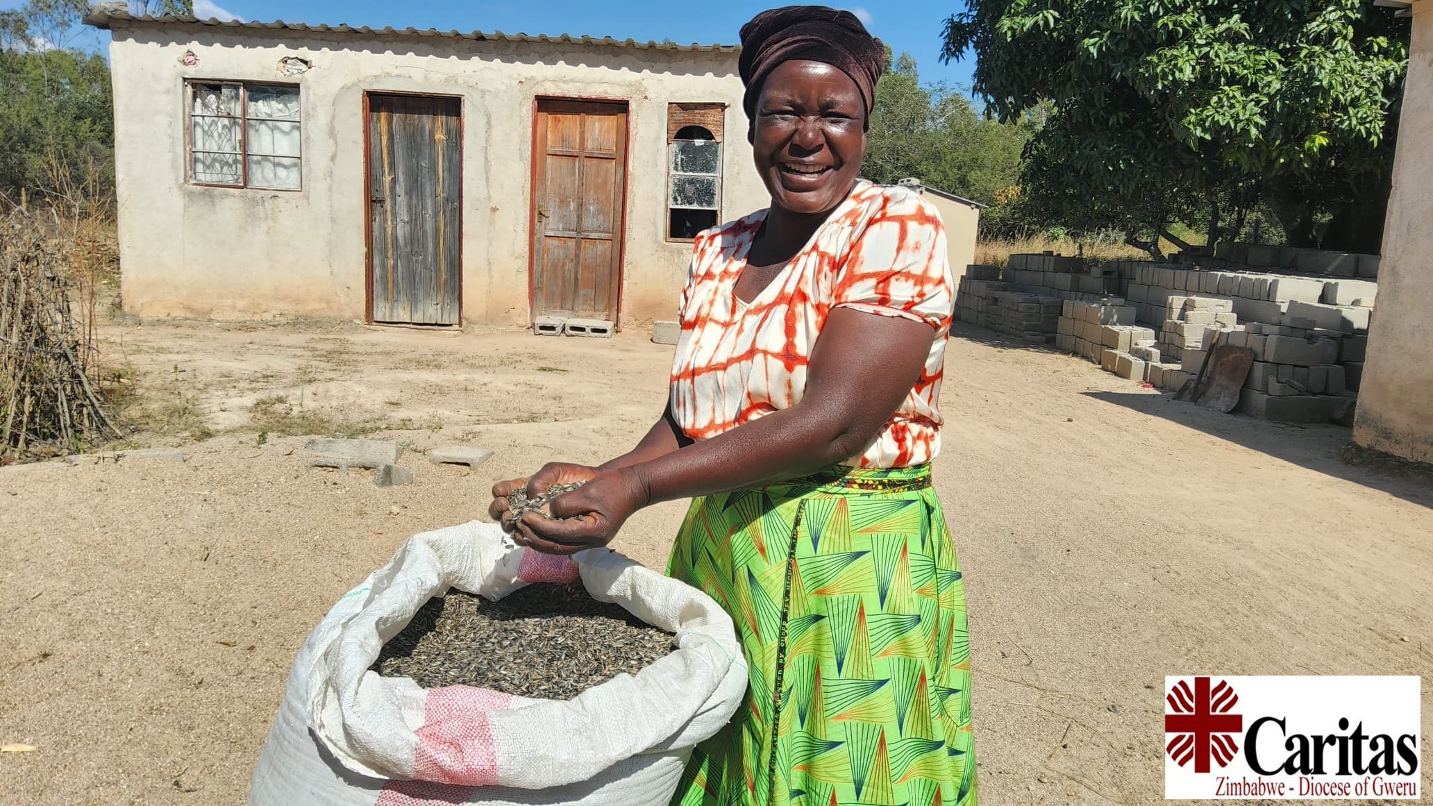 A farmer in the Diocese of Gweru with seed from her harvest